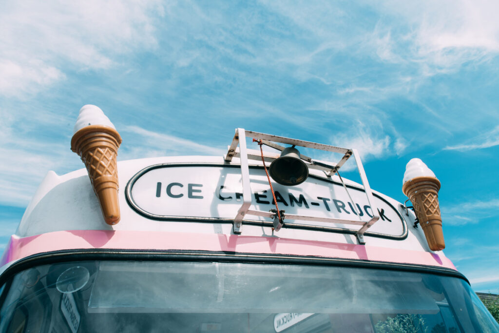 The top front of a pink and white ice cream truck in Norman.